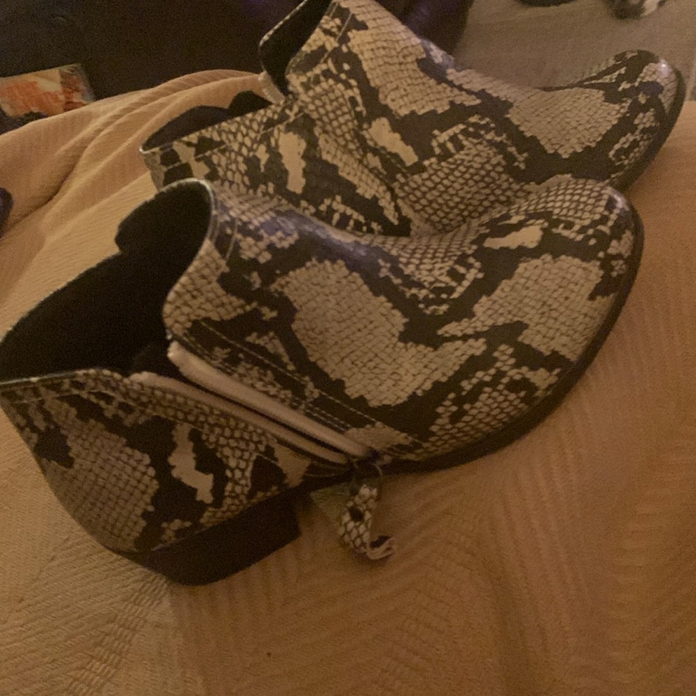 A stylish pair of ankle boots.  Worn but new. Color is do brown with beige